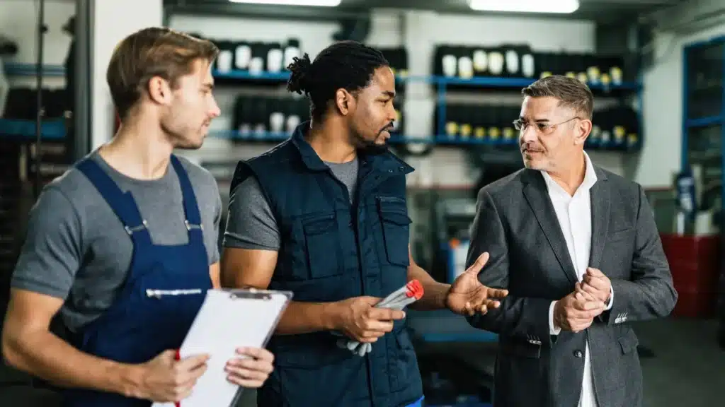 Operations team collaborating on the shop floor of a metal fabrication startup facility