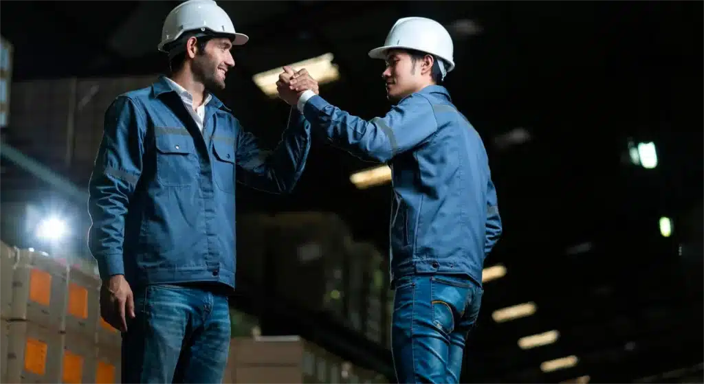 Operations manager and plant manager overseeing manufacturing operations in industrial facility